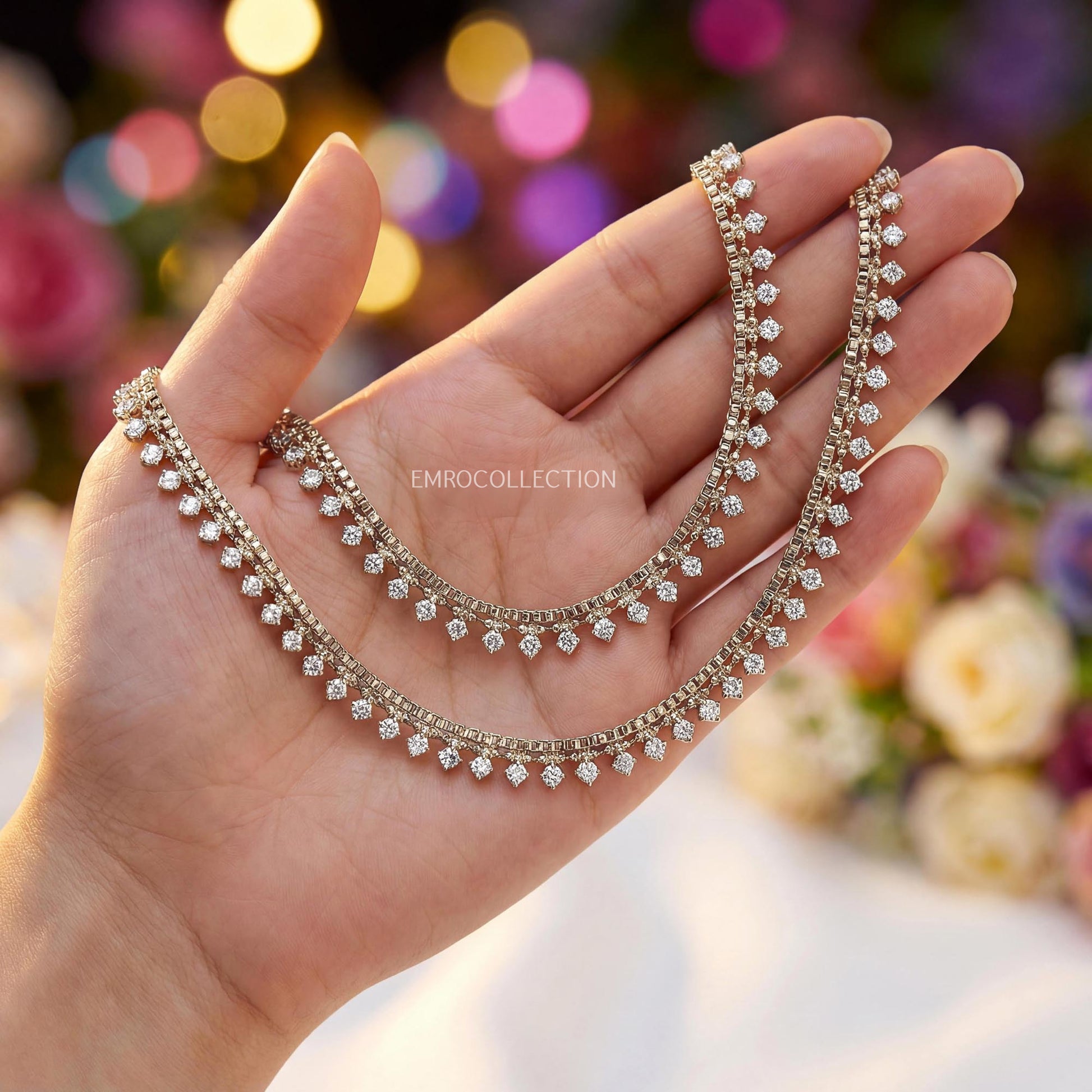 antique golden anklets held in a hand with a blurred floral background - Trending Pakistani jewellery