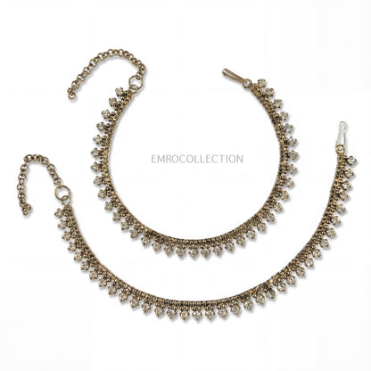 Indian Pakistani style antique golden anklets on a white background