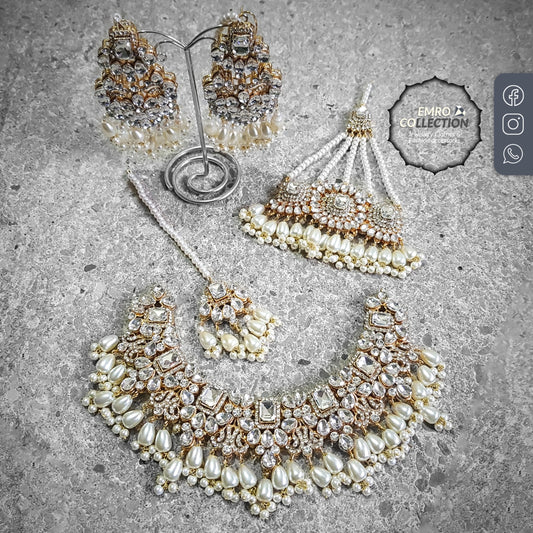 Handcrafted bright golden necklace set with cream pearls, earrings, jhoomar, and tikka, perfect for parties and festive occasions.