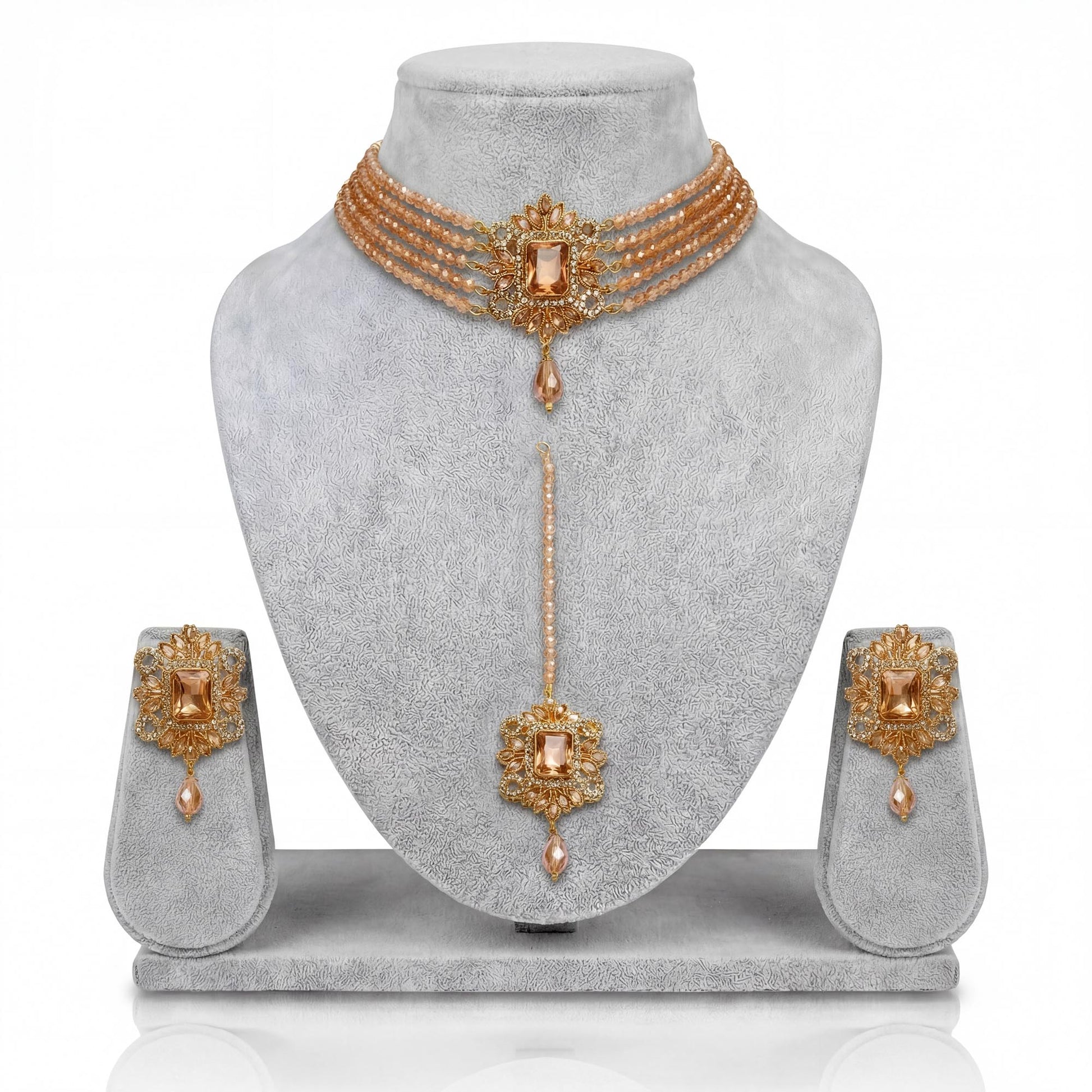 Champagne choker set with earrings and a maang tika on a gray mannequin pakistani jewellery