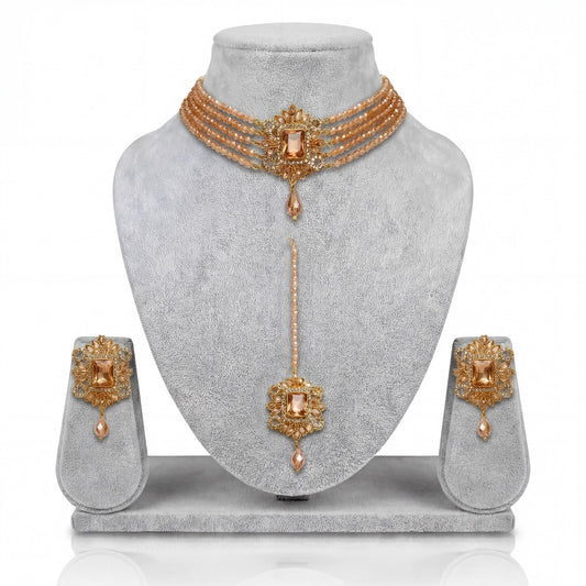 Champagne choker set with earrings and a maang tika on a gray mannequin pakistani jewellery