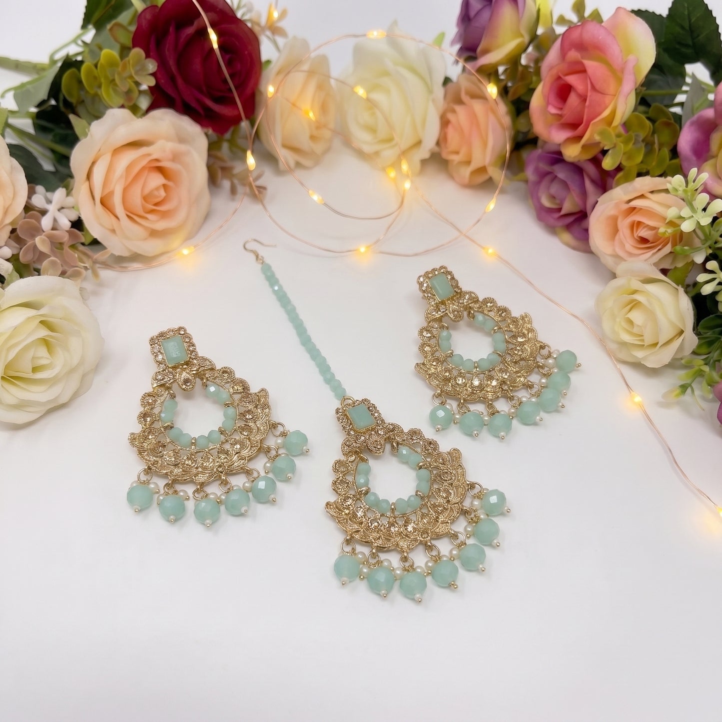 golden and light green earrings tikka set