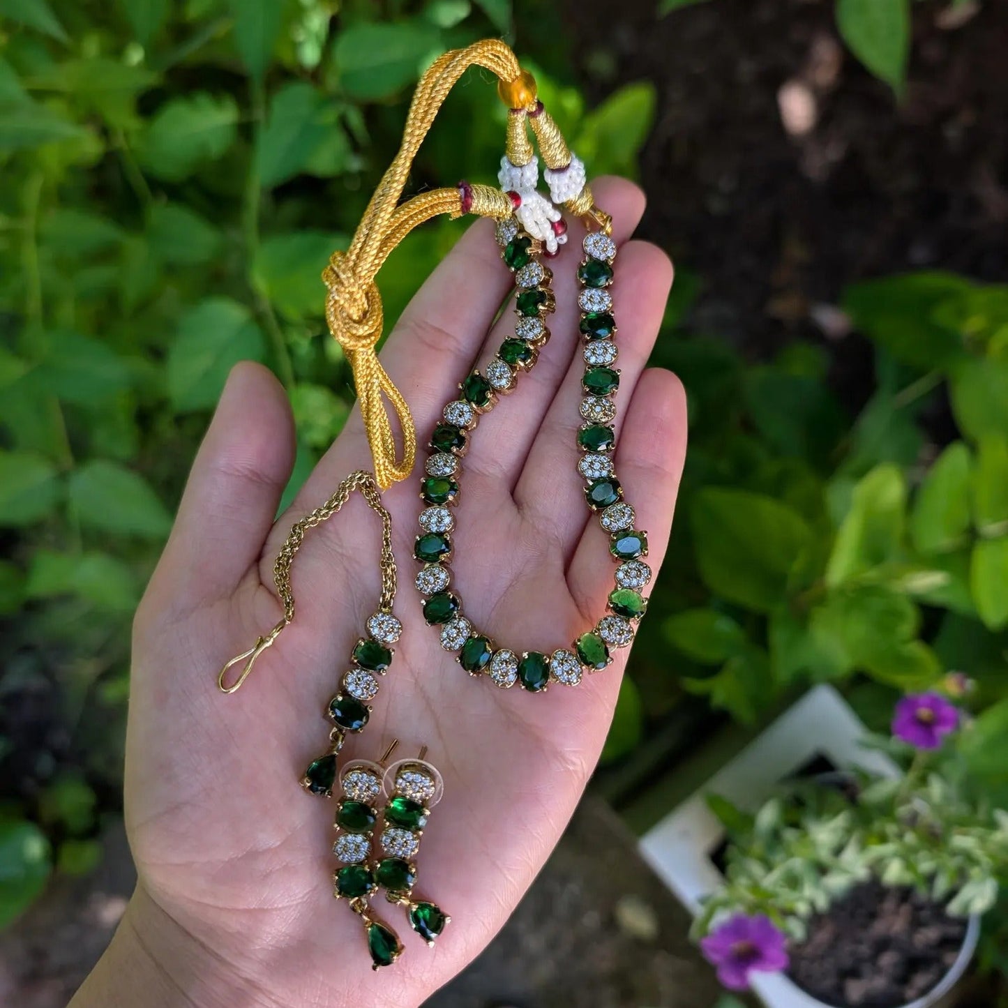 model wearing the green choker necklace set with earrings and tikka for a complete bridal look