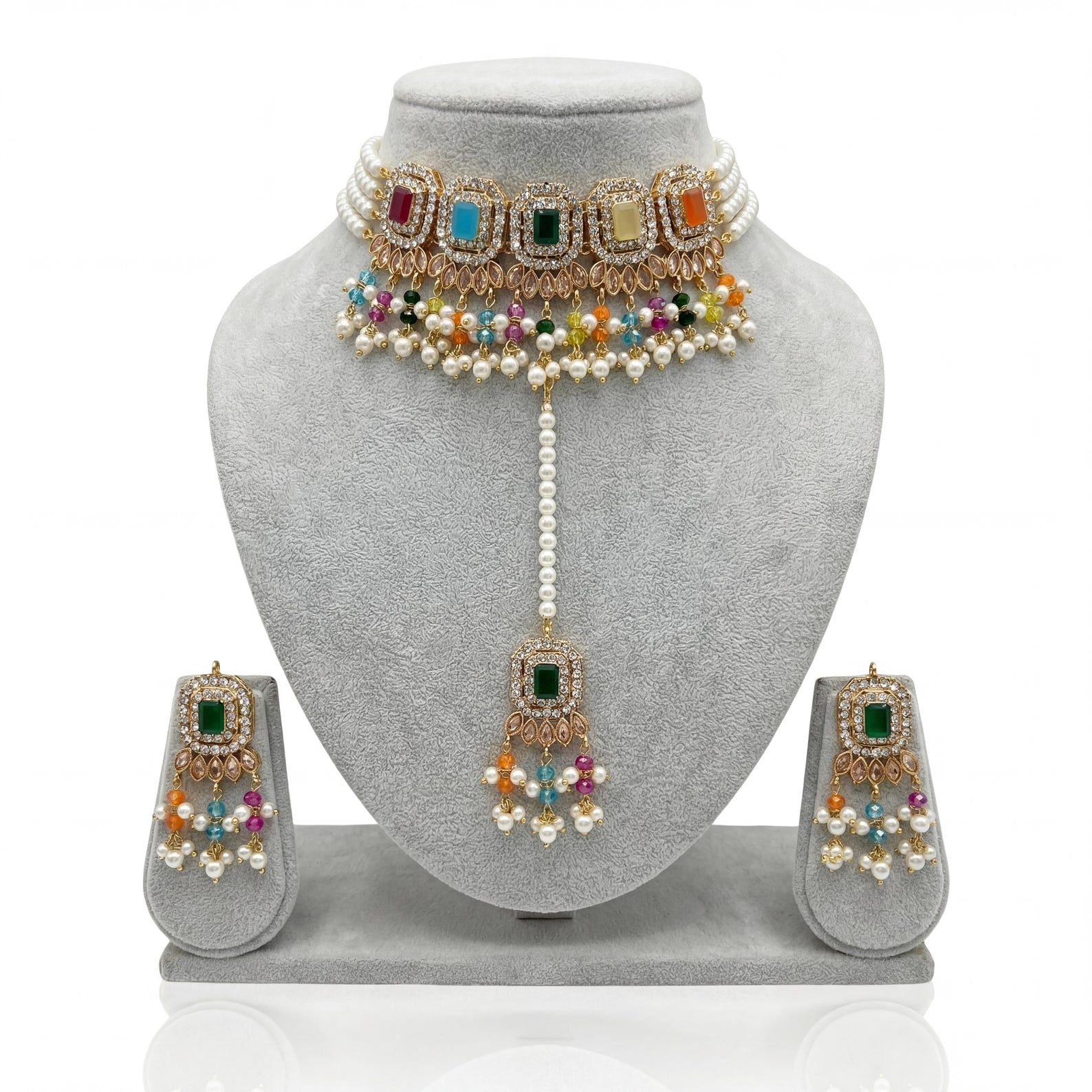 The nine-piece Multi Choker Necklace Set with Earrings and Maang Tikka spread out for viewing
