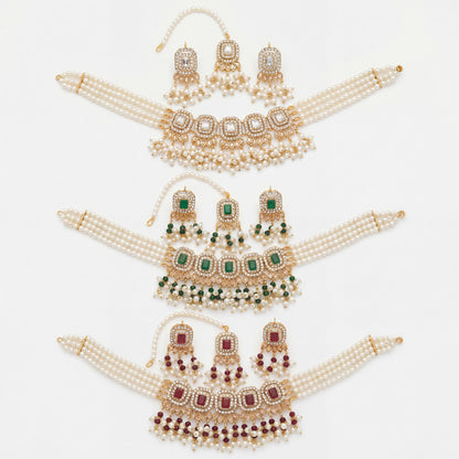 Set of gold and pearl jewelry with green and maroon stones on a white background simple pakistani choker necklace
