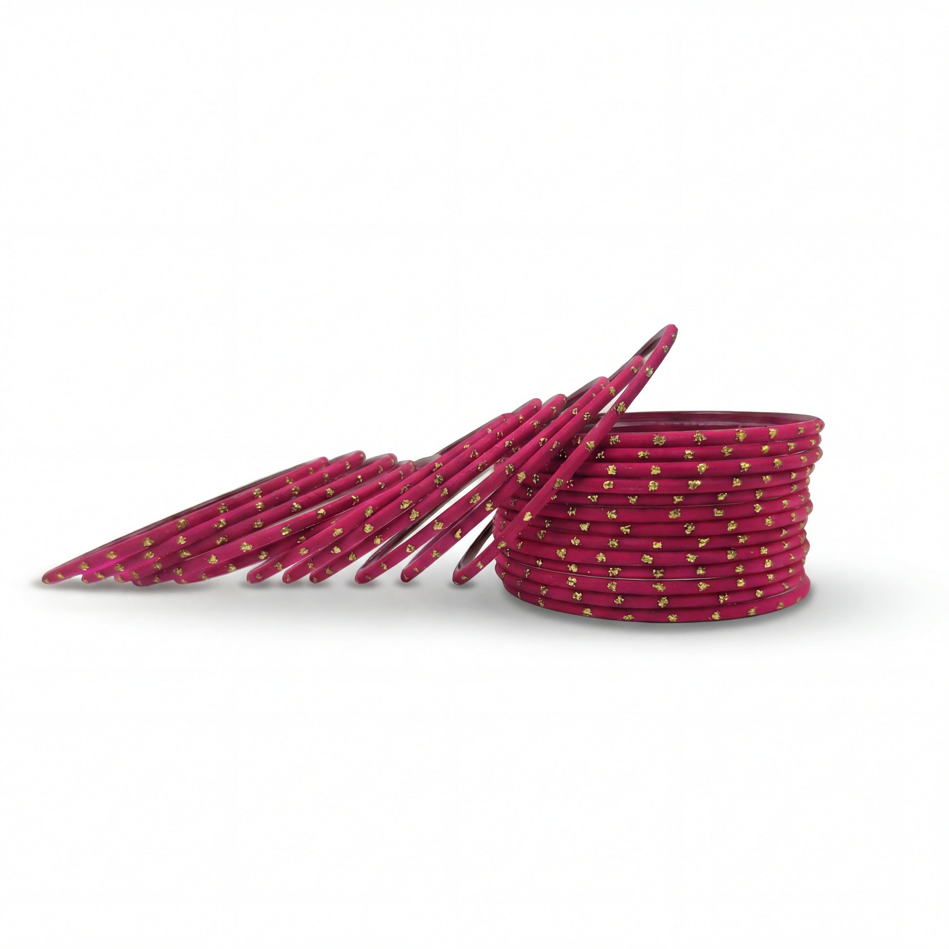 Close-up of shocking pink bangles with golden dots stack highlighting polished finish and bridal Indian jewellery craftsmanship