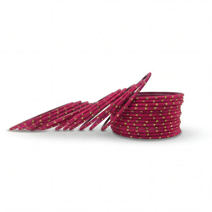 Close-up of shocking pink bangles with golden dots stack highlighting polished finish and bridal Indian jewellery craftsmanship