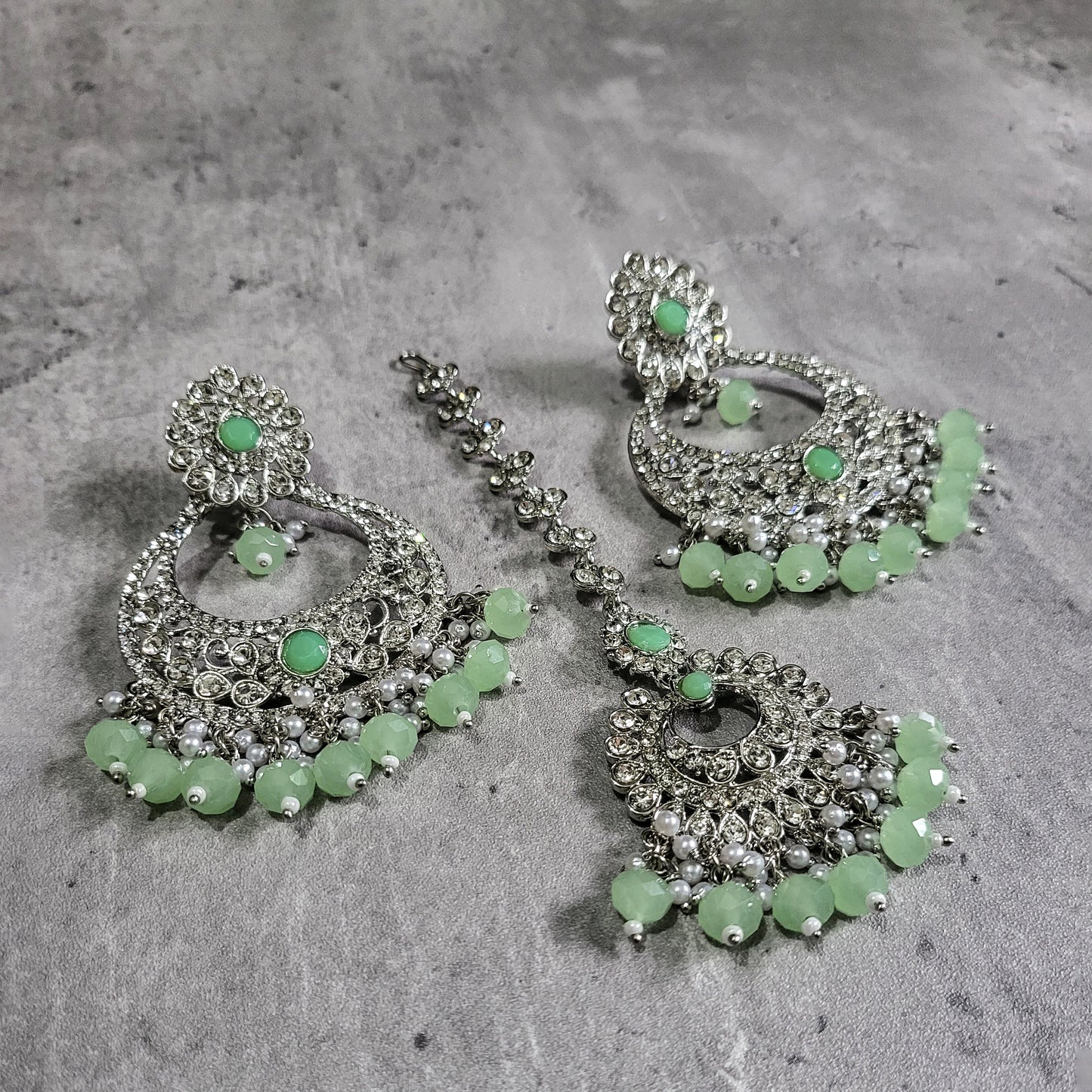 silver mint green earrings tikka set styled elegantly on a mannequin for a trending festive look