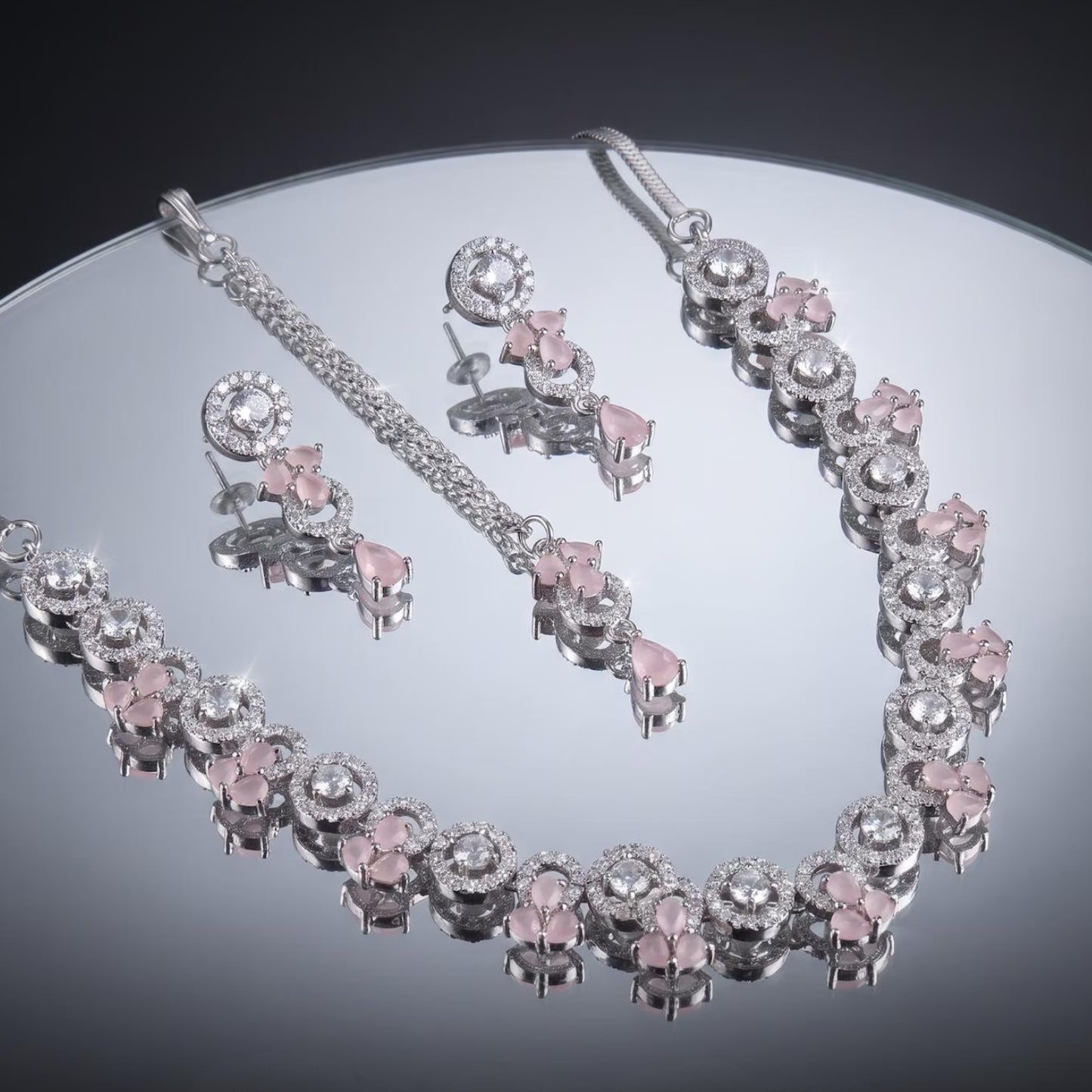zoomed view of the silver and baby pink necklace capturing its fine metal work and finishing
