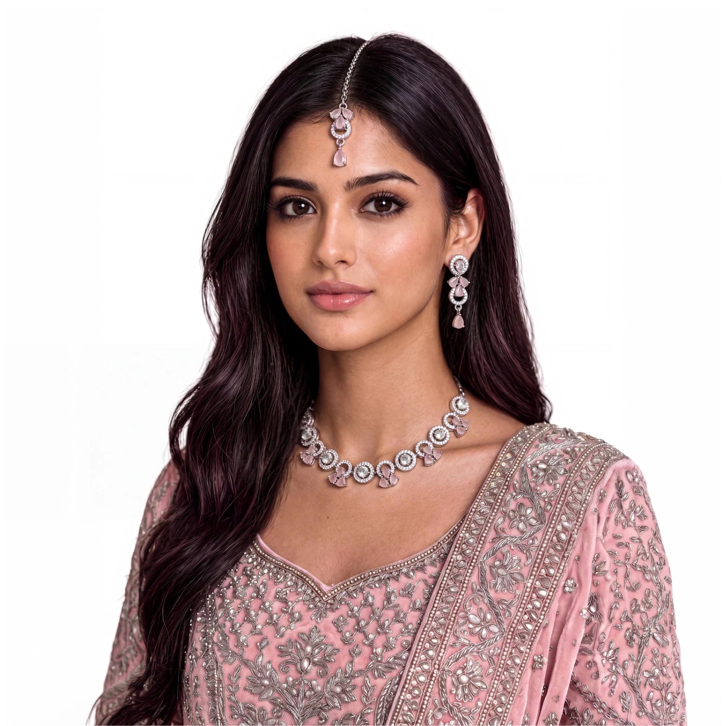 a model wears the complete silver and baby pink necklace, earrings and tikka set for an event