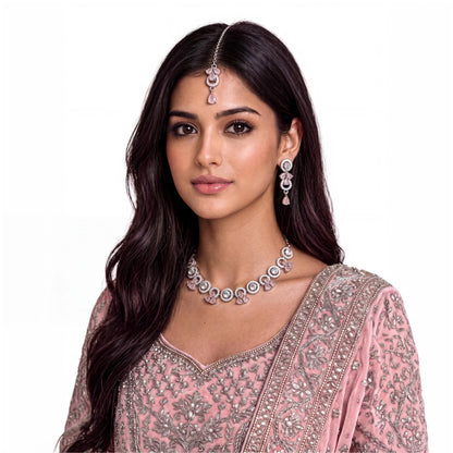 A model wears the complete Silver and Baby Pink Necklace, Earrings and Tikka Set for an event