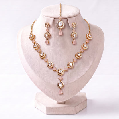 The full Simple Baby Pink Necklace, Earrings and Tikka Set spread out neatly on a plain surface