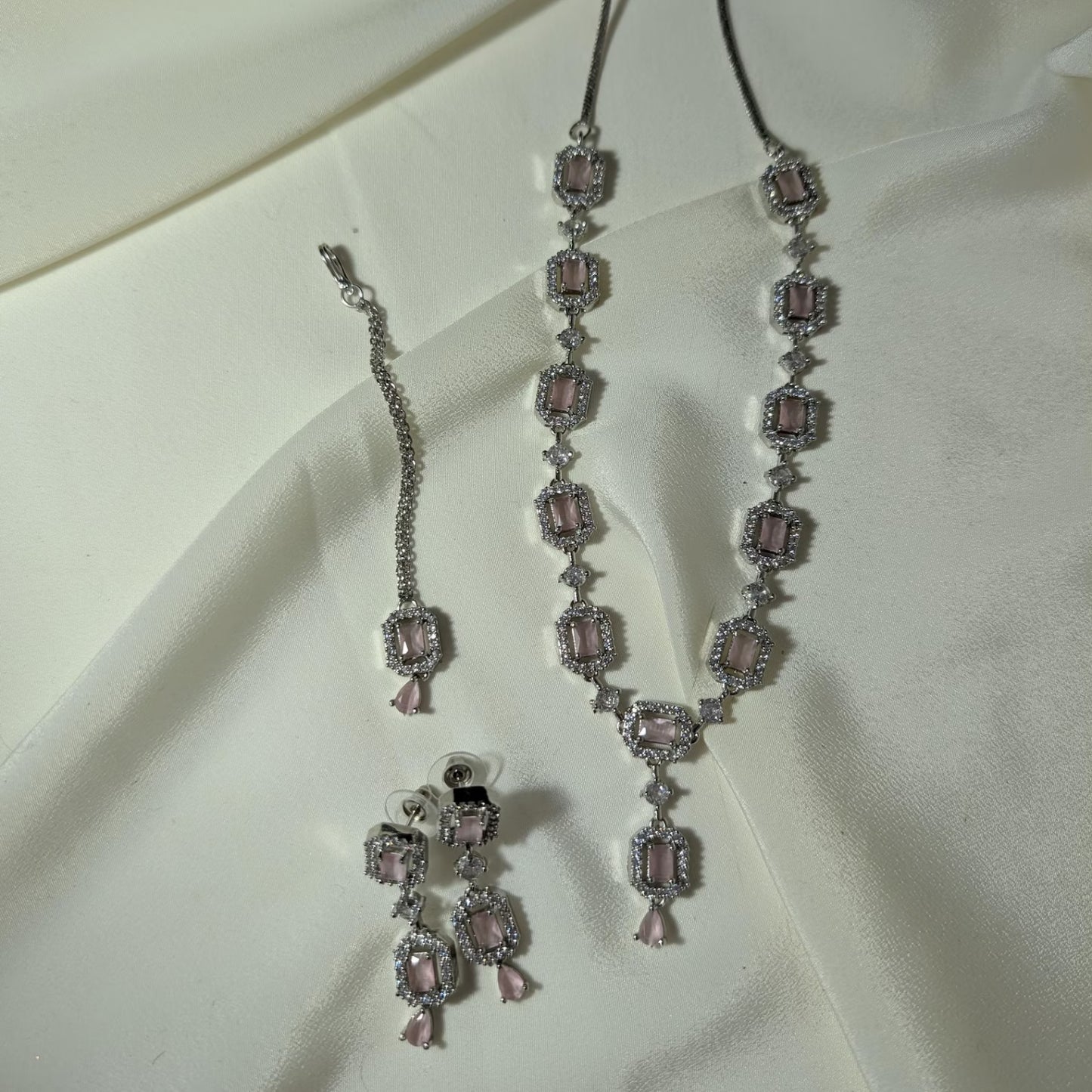 baby pink necklace set styled elegantly on a mannequin for a wedding and party jewellery look