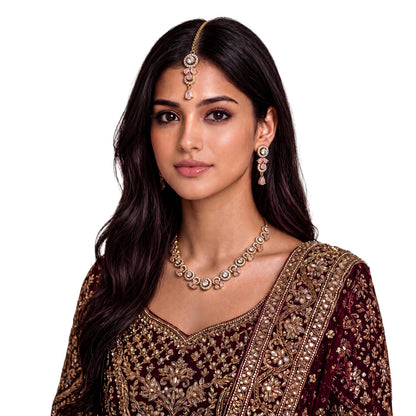 This gold and baby pink necklace set styled on a mannequin, dressed for a wedding or party look