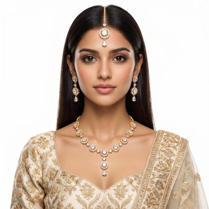 A model completes her outfit wearing the Simple Gold and White Necklace, Earrings and Tikka Set