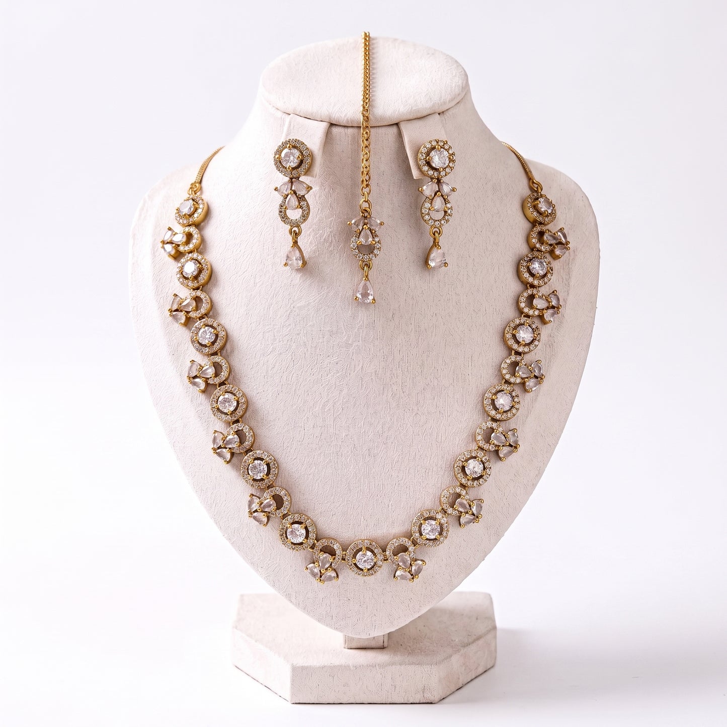 simple gold and white necklace set with earrings and tikka displayed together showing detailing