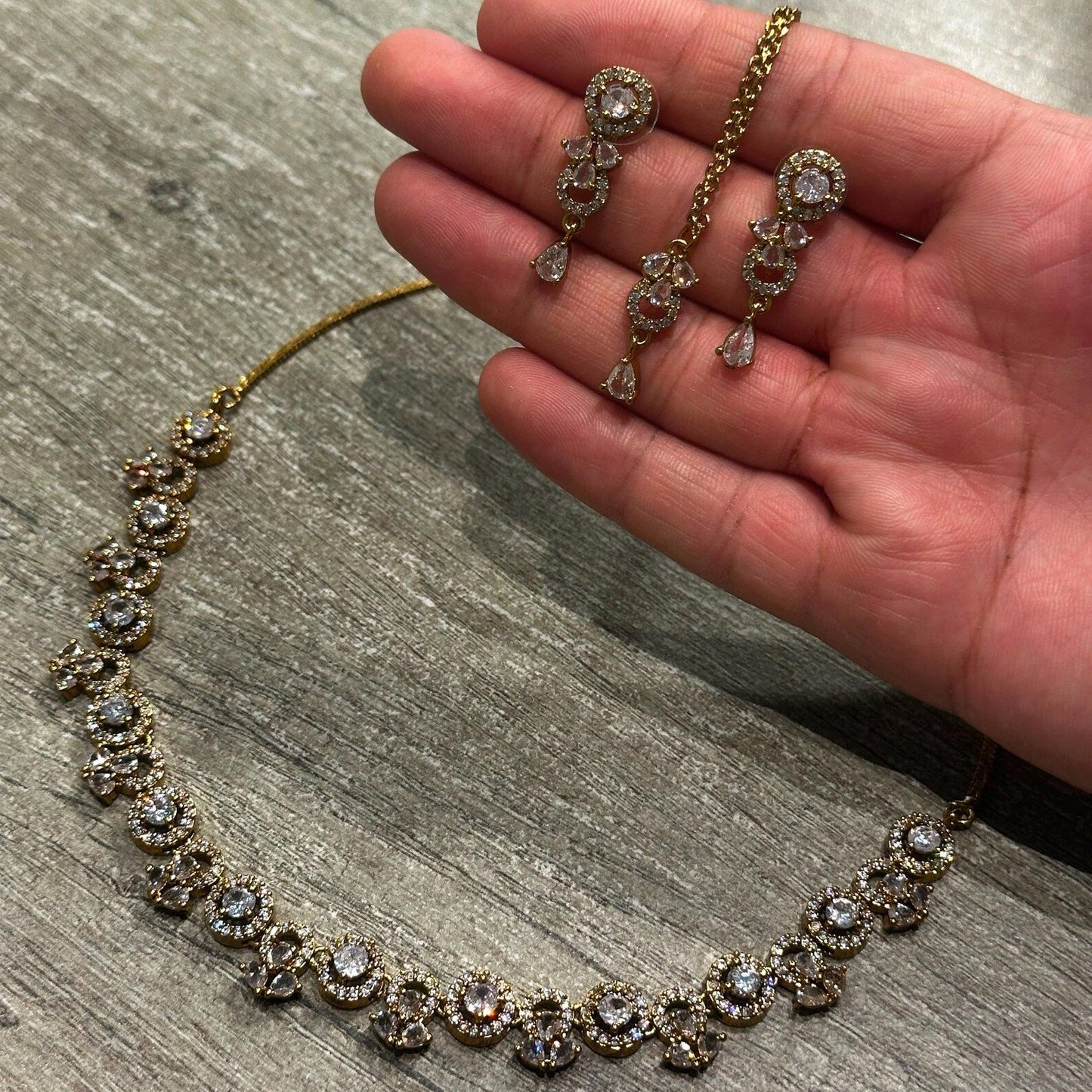 close-up of the gold and white necklace highlighting delicate craftsmanship and polished finish