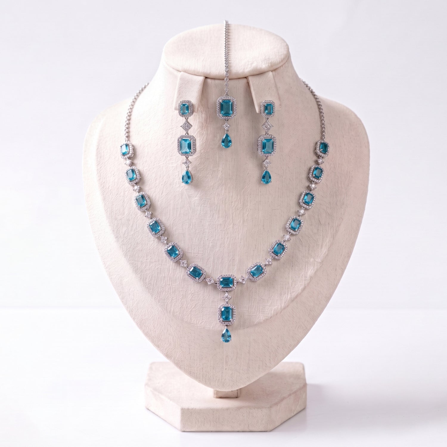 The Simple Light Blue Necklace, Earrings and Tikka Set laid out together on a plain backdrop
