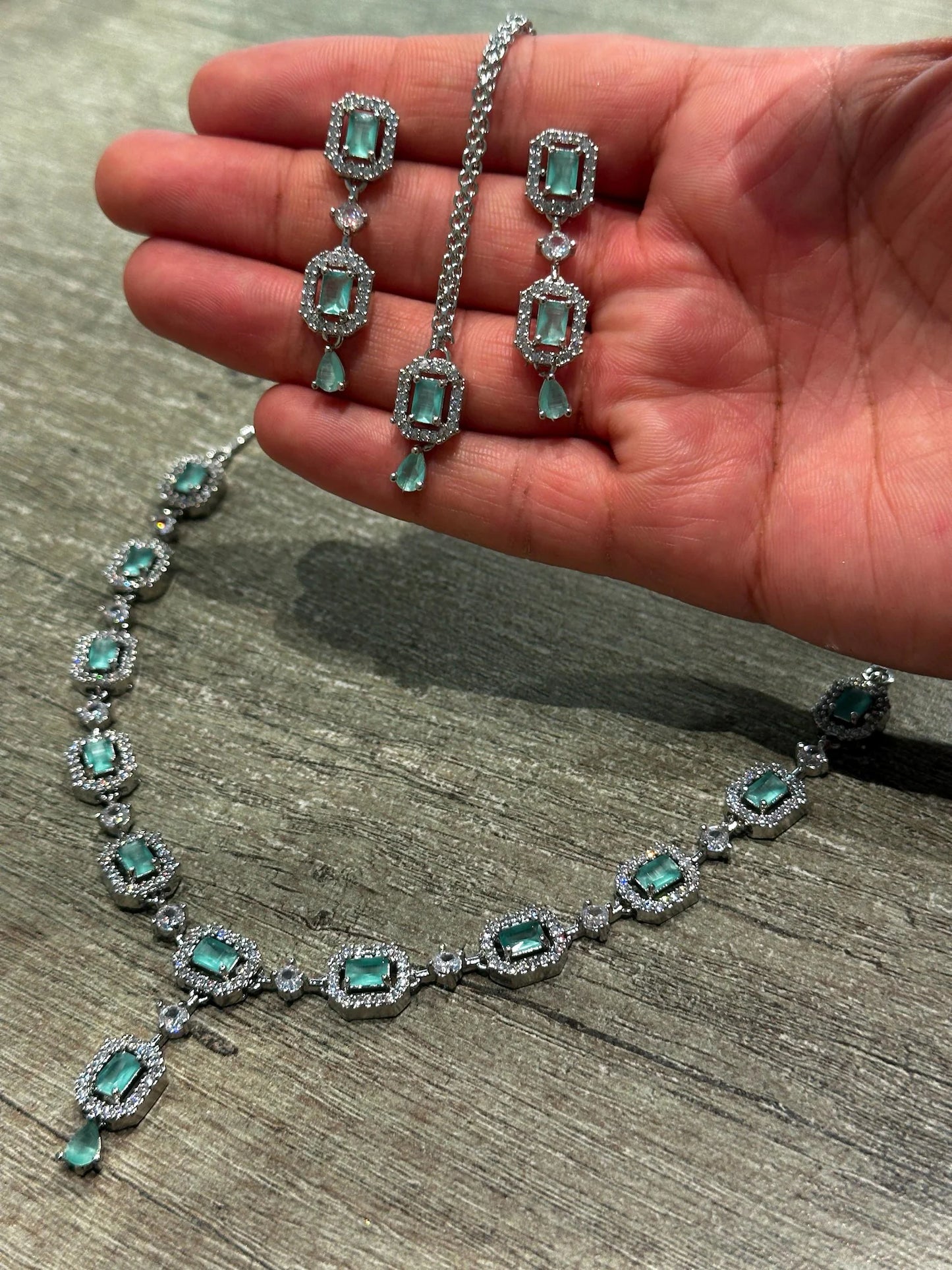 mint green necklace set styled elegantly on a mannequin for a wedding and party jewellery look