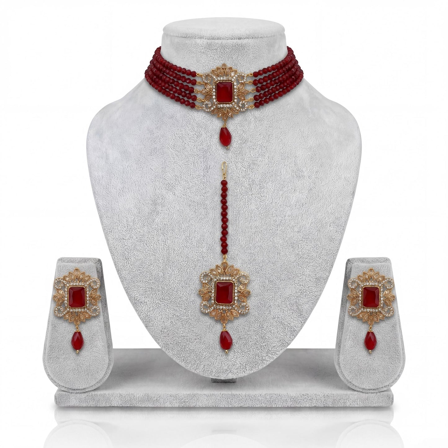 pakistani maroon choker set with matching earrings and maang tikka on display pakistani  jewellery