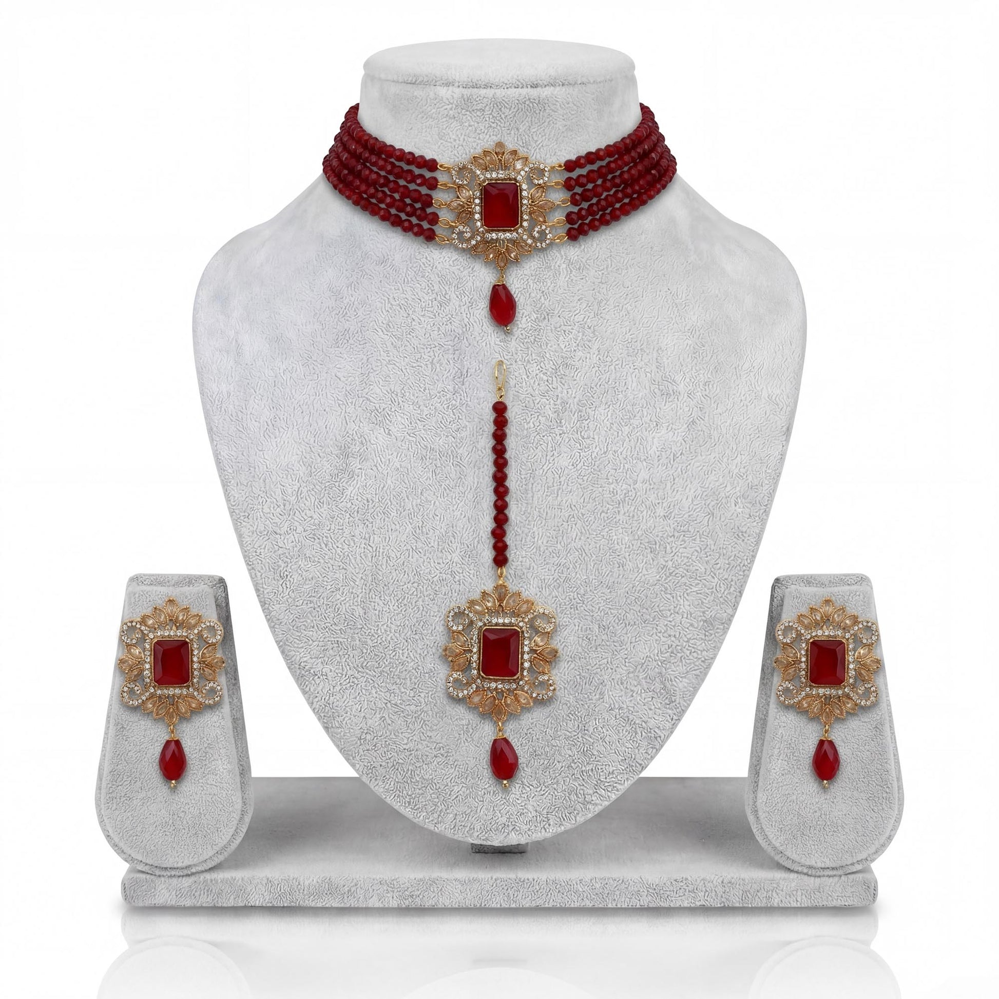 Pakistani maroon choker set with matching earrings and maang tikka on display Pakistani  jewellery