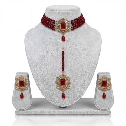 Pakistani maroon choker set with matching earrings and maang tikka on display Pakistani  jewellery