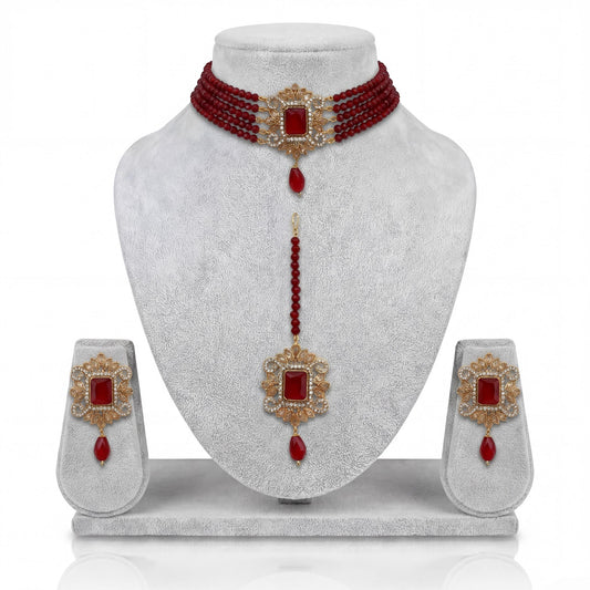 Pakistani maroon choker set with matching earrings and maang tikka on display Pakistani  jewellery