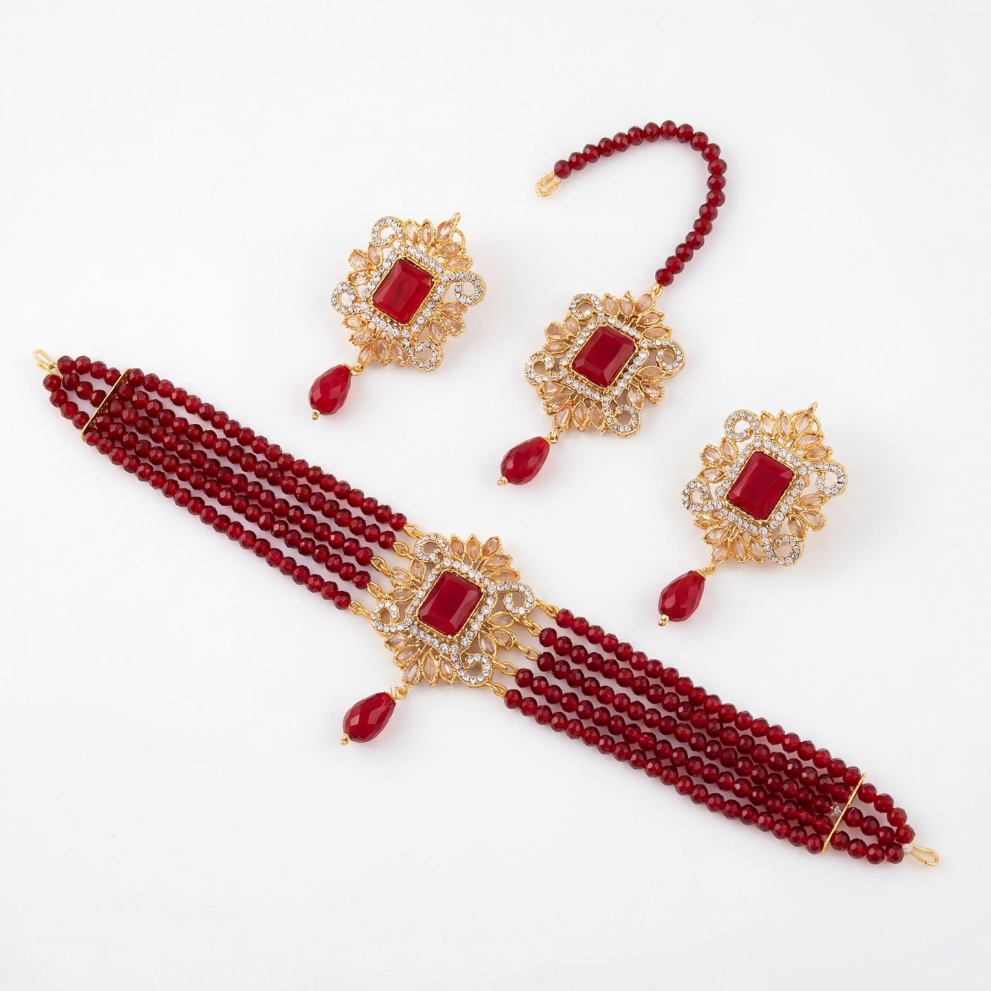 set of maroon beaded jewelry with gold accents on a white background pakistani choker