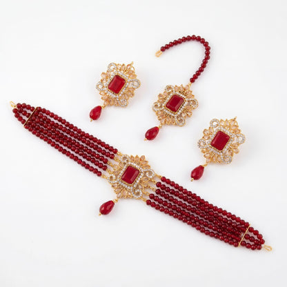 Set of Maroon beaded jewelry with gold accents on a white background pakistani choker