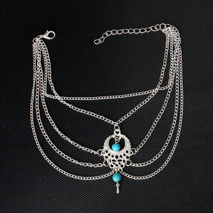 Trendy Bohemian anklets with silver chains and turquoise accents, perfect for adding style to casual and beachwear looks