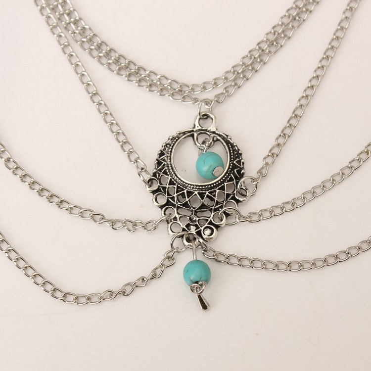 Stylish Bohemian anklets featuring intricate silver chain design and turquoise accents, perfect for casual and beach looks