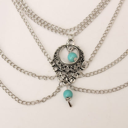 Stylish Bohemian anklets featuring intricate silver chain design and turquoise accents, perfect for casual and beach looks