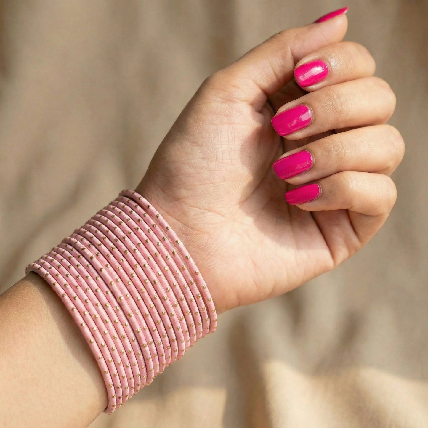 model wearing baby pink bangles on wrist showing elegant slim stack in pakistani bridal jewellery style indian jewellery