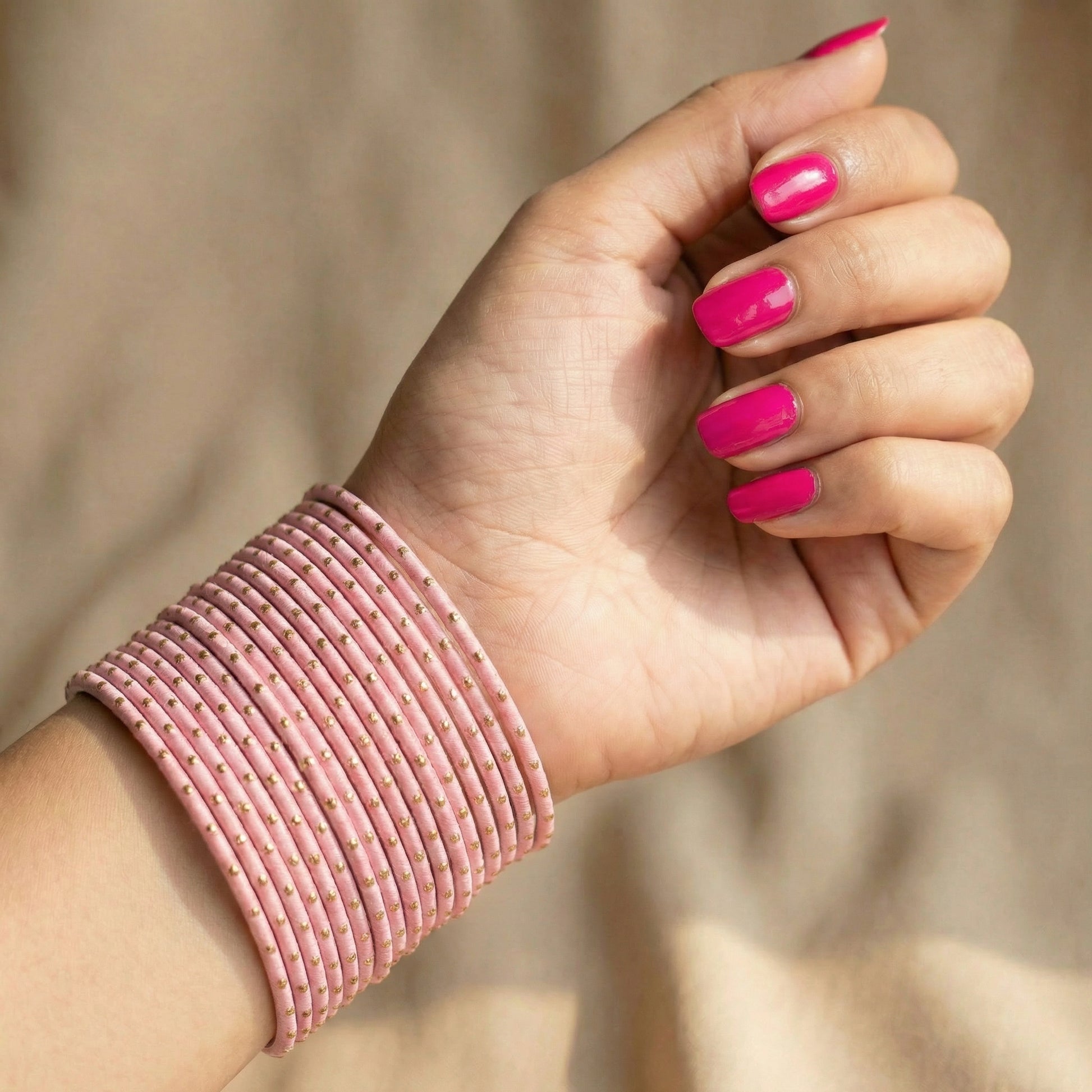 Model wearing baby pink bangles on wrist showing elegant slim stack in Pakistani bridal jewellery style indian jewellery