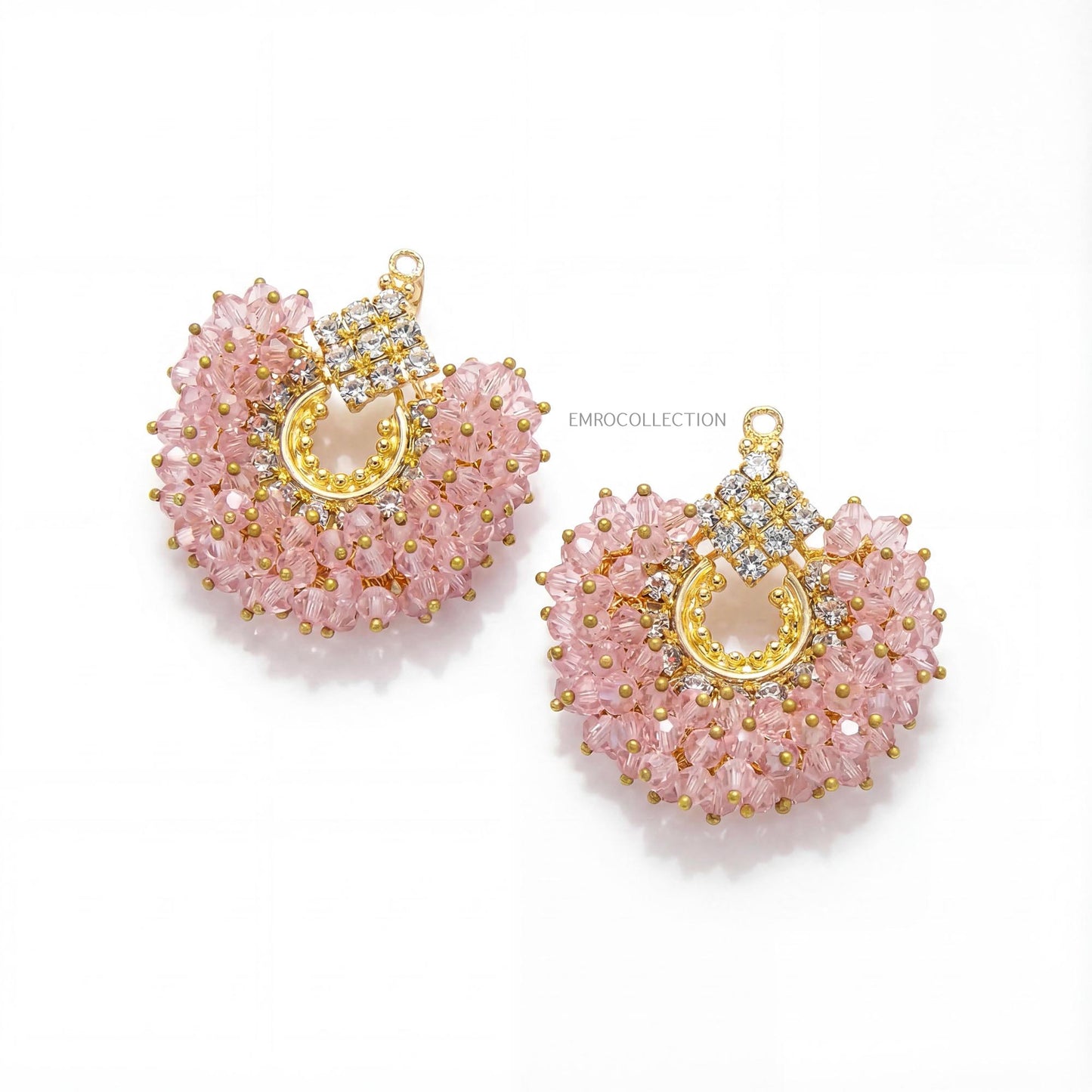 pair of baby pink beaded earrings with gold accents on a white background