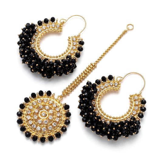 Black Chand Bali earrings with Maang Tikka on a white background. trending pakistani jewellery
