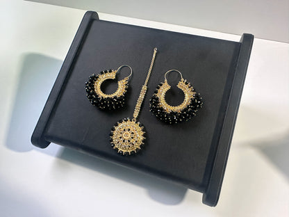 Elegant black Chand Bali earrings tikka set on a black display. trending pakistani jewellery