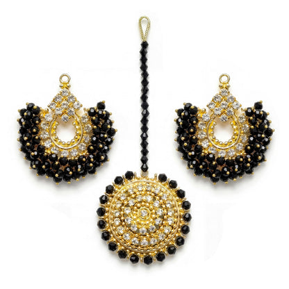 gold and black chand bali earrings and maang tikka on a white background - trending pakistani jewellery