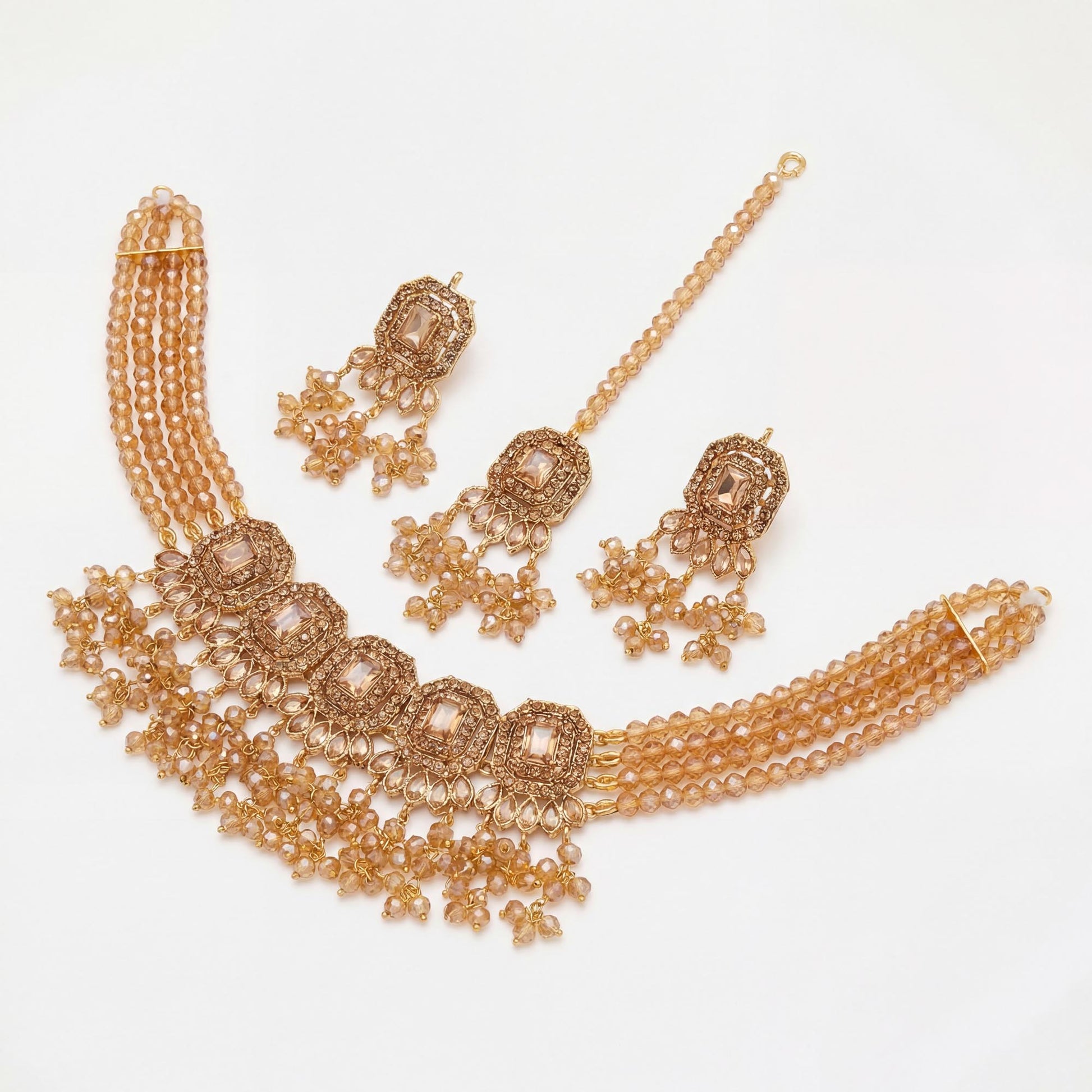 Simple golden choker set with earrings and maang tikka displayed on a clean white background – pakistani jewellery