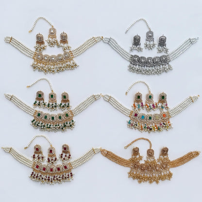 collection of simple pakistani golden choker necalce sets with earrings and maang tikkas. high end Pakistani jewellery