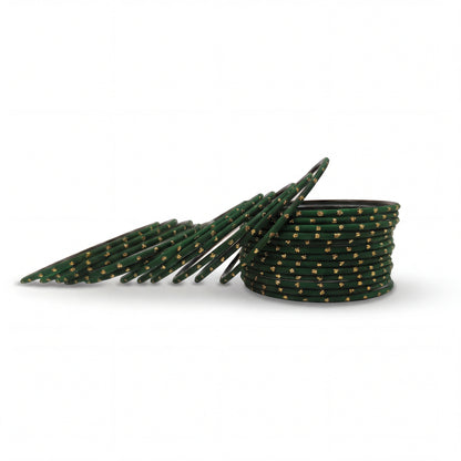 Dark green bangles with golden dots churi set arranged together showing slim elegant Indian jewellery design indian jewellery