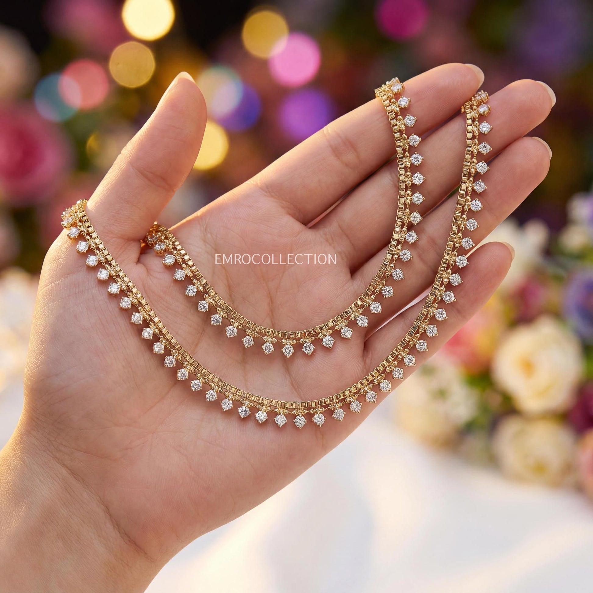 Gold anklets on a hand with a blurred floral background - Trending pakistani jewellery