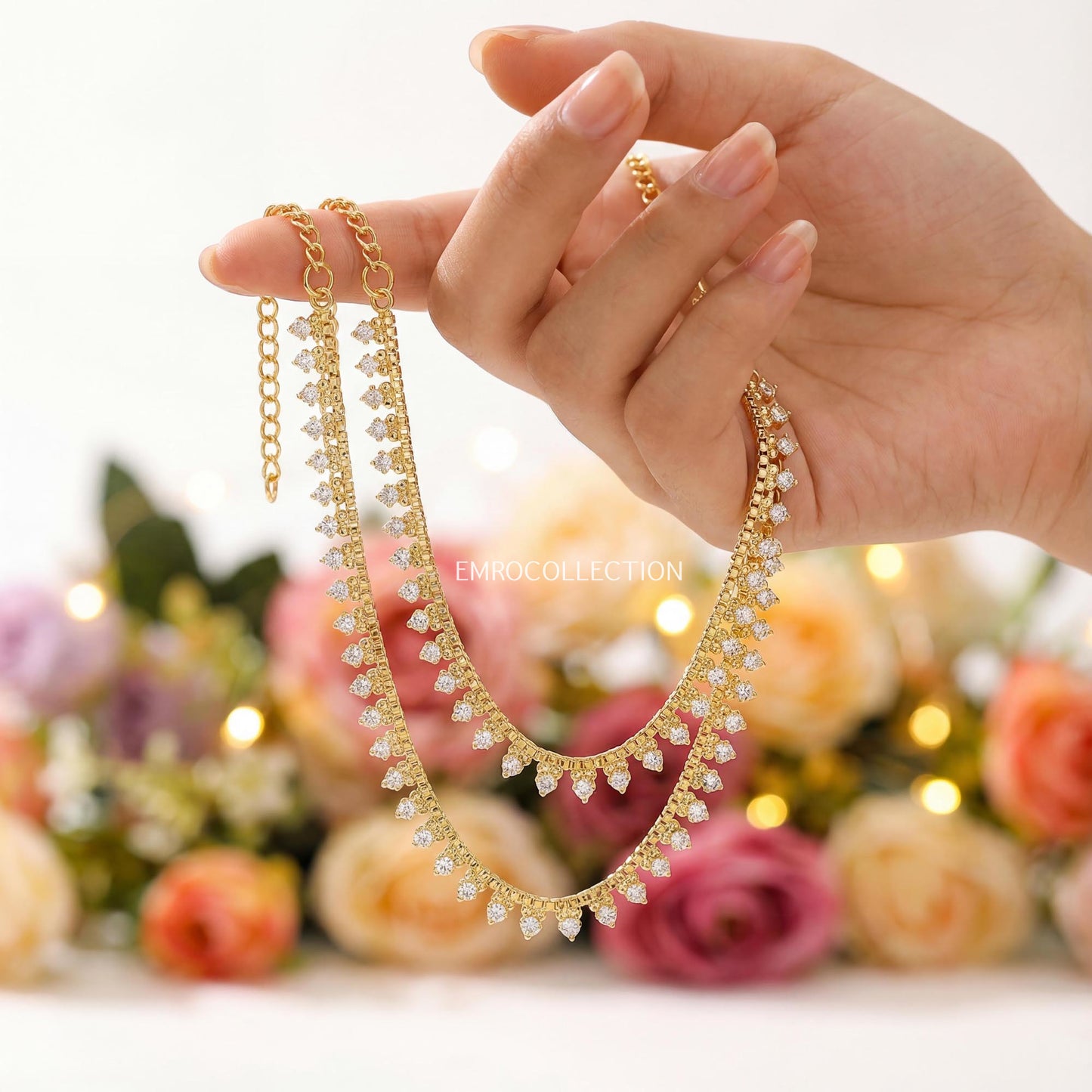 hand holding a golden anklet payal traditional indian and pakistani jewellery
