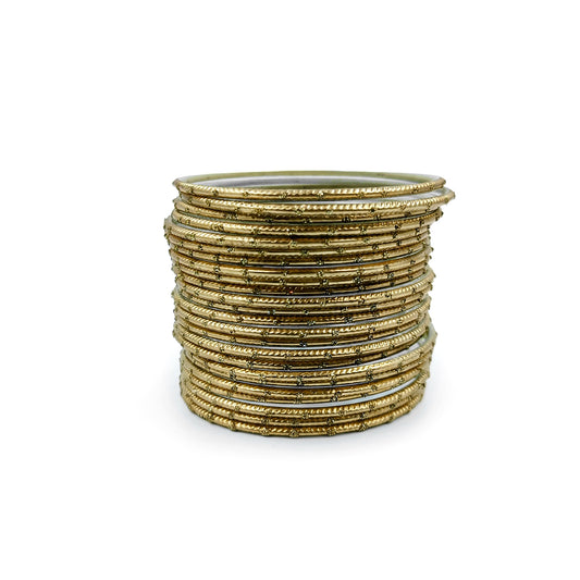 Golden bangles with golden dots churi set arranged together showing slim elegant Indian jewellery design indian jewellery