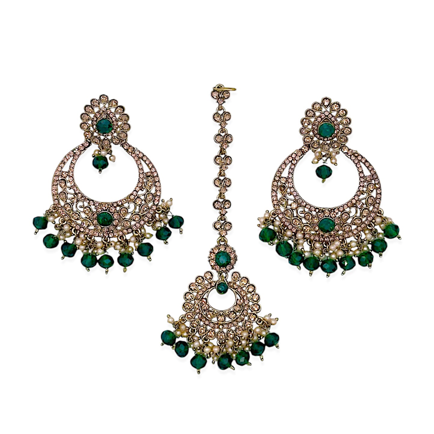 green maang tikka and earrings combo displayed together showcasing emerald stone detailing and gold tone finish