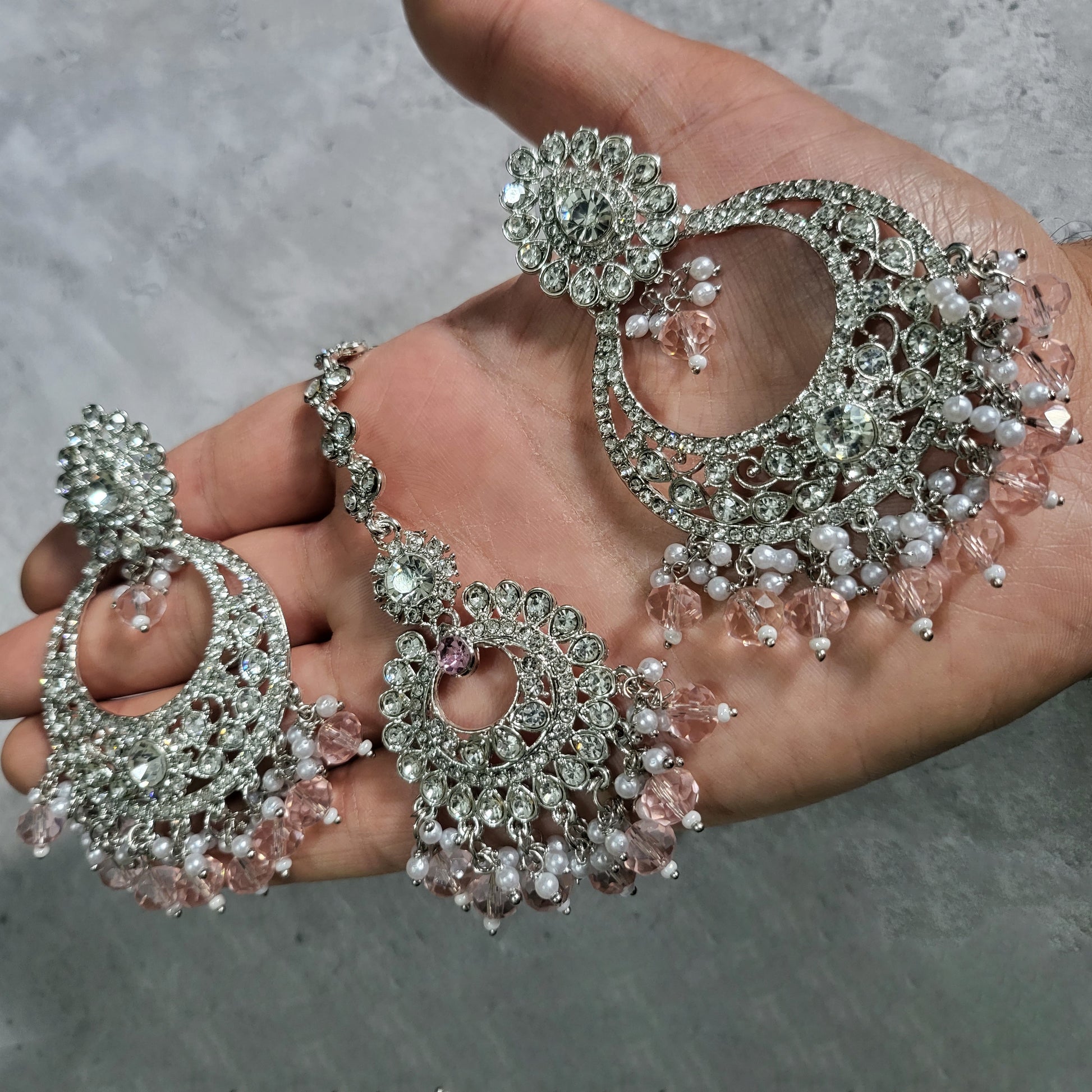 Shop the latest trend: silver and baby pink earrings tikka set