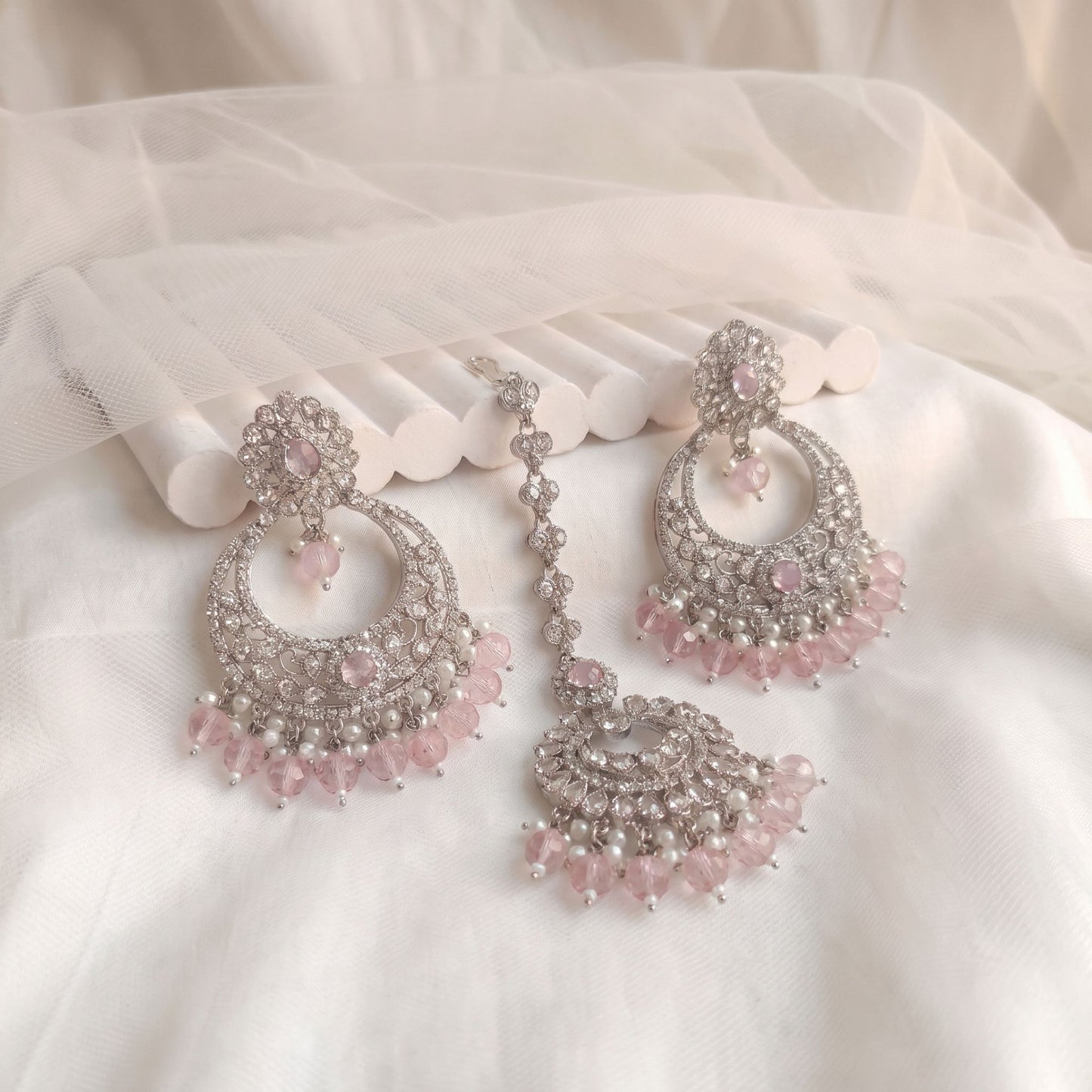 silver and baby pink earrings tikka set