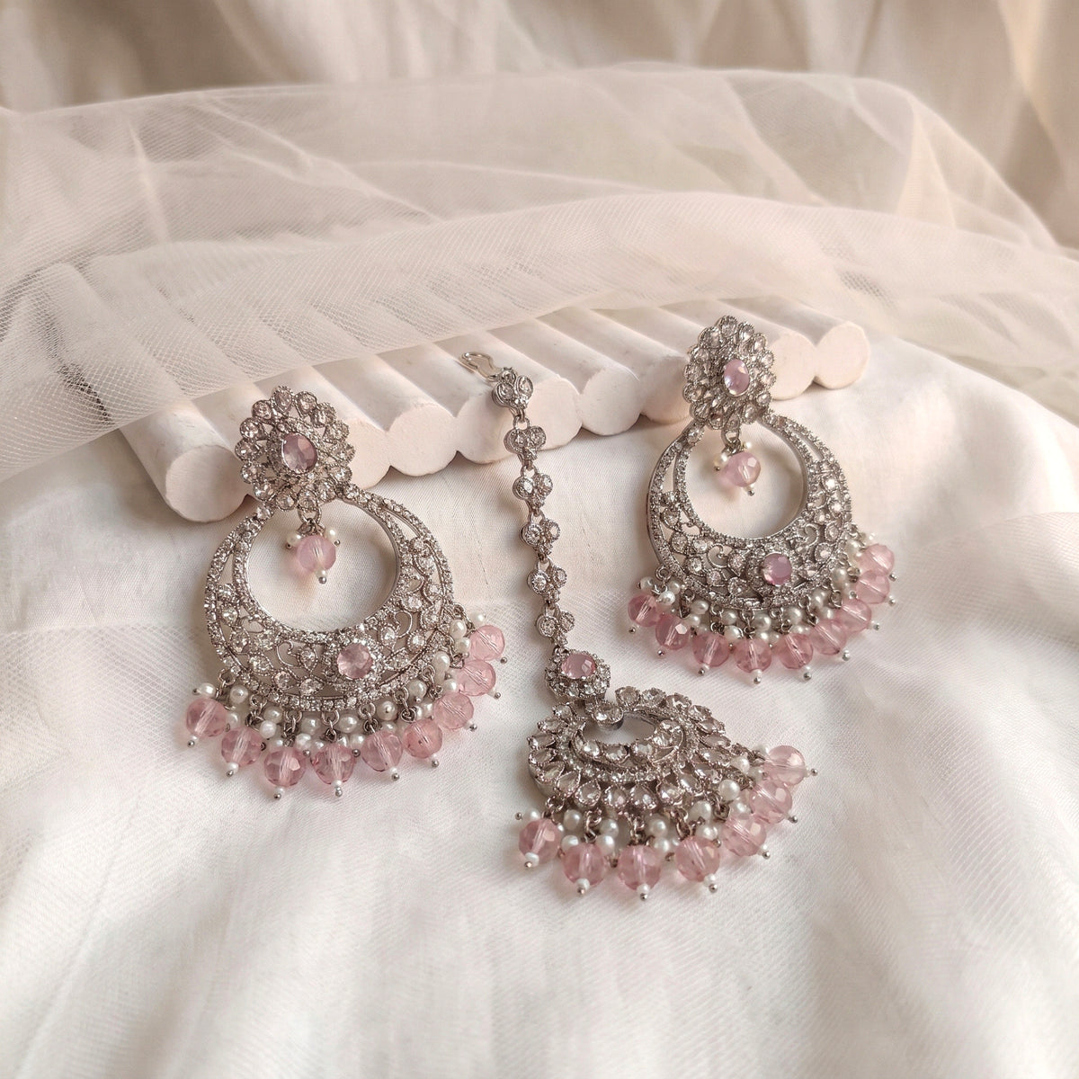 silver and baby pink earrings tikka set