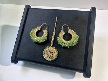 mint green earrings tikka on a black display. trending chand bali earrings tikka set
