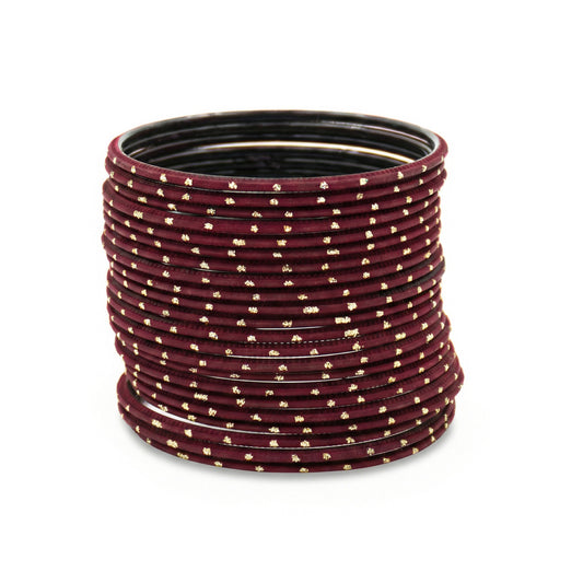 Close-up of maroon bangles with golden dots stack highlighting polished finish and bridal Indian jewellery craftsmanship indian jewellery